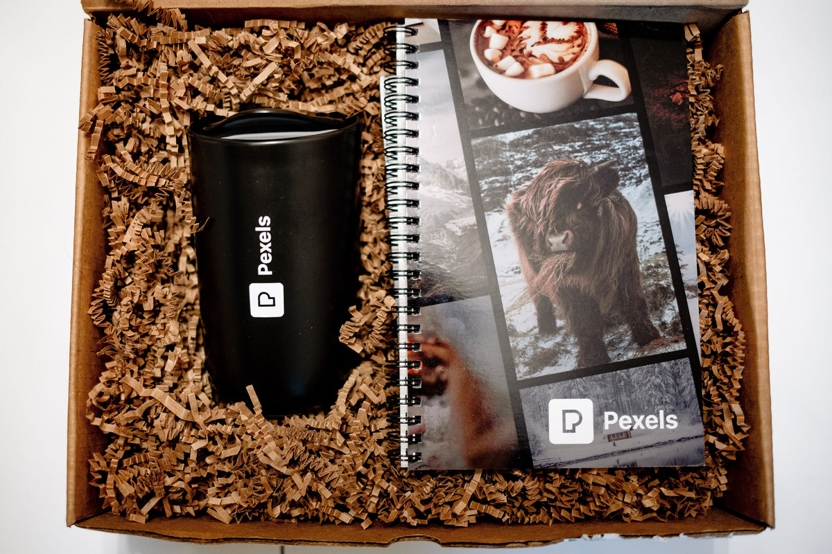 Branded employee gift box with a reusable tumbler and spiral notebook
